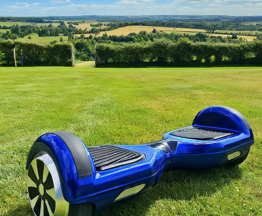 Sleek Hoverboard on a sunny summer day in a scenic UK park.